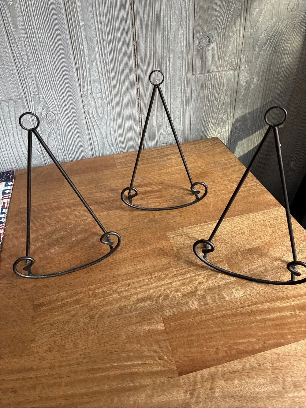 3 black wrought iron tabletop display easel featuring a triangular frame